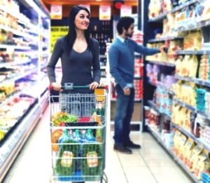 Two shoppers browsing items inside a supermarket