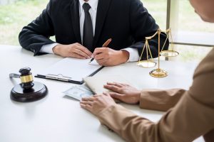 A solicitor discussing a holiday accident claim with their client.