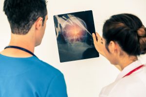 Two doctors assess the serious head injuries of a patient after an accident