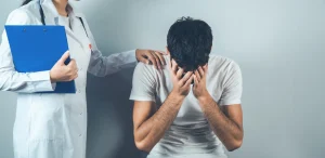 Woman with hand on crying man's shoulder.